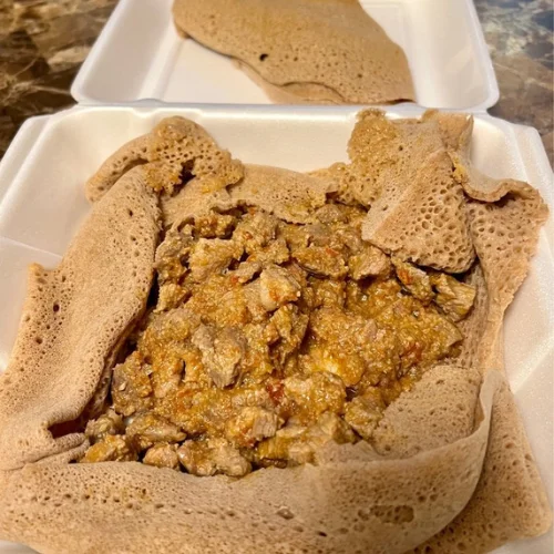 Yebeg Tibs - Tender lamb sautéed with onions, peppers, garlic, and aromatic Ethiopian spices — a hearty and flavorful favorite.